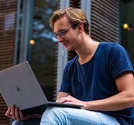 A University of Bridgeport online student using a laptop